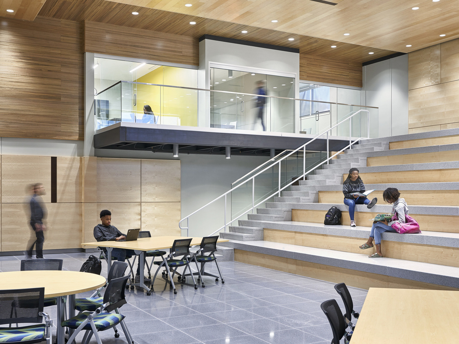 Topeka Center for Advanced Learning & Careers double height interior wood panel room with learning steps to 2nd floor hallway