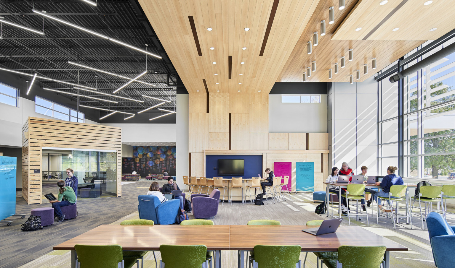 Interior view with table and tall ceilings with wood panel accents at Topeka Center for Advanced Learning & Careers