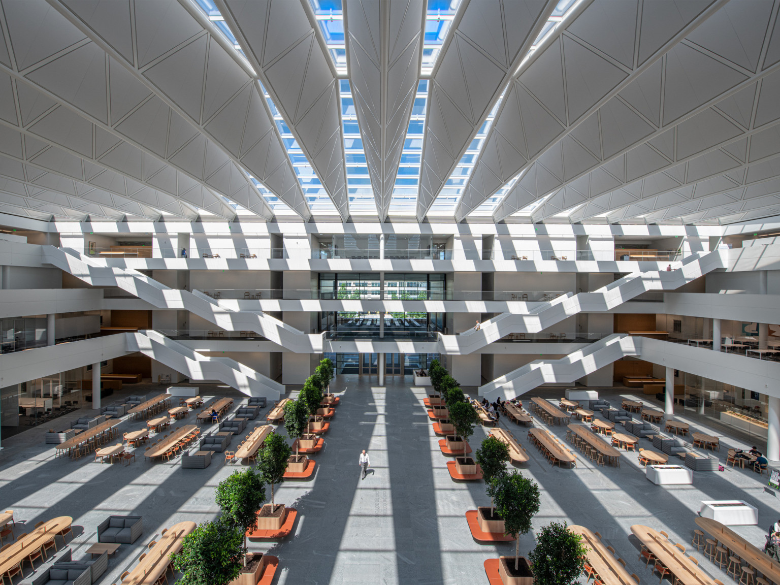 White atrium in 4 story Sheila and Eric Samson Pavilion Health Education Campus. White bannisters and walkways come to center