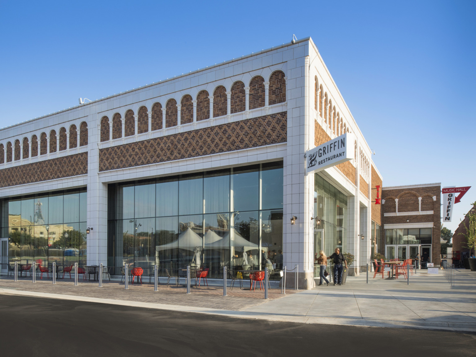 White stone details on building with geometric brick design, a white sign hangs from the corner reading Griffin Restaurant