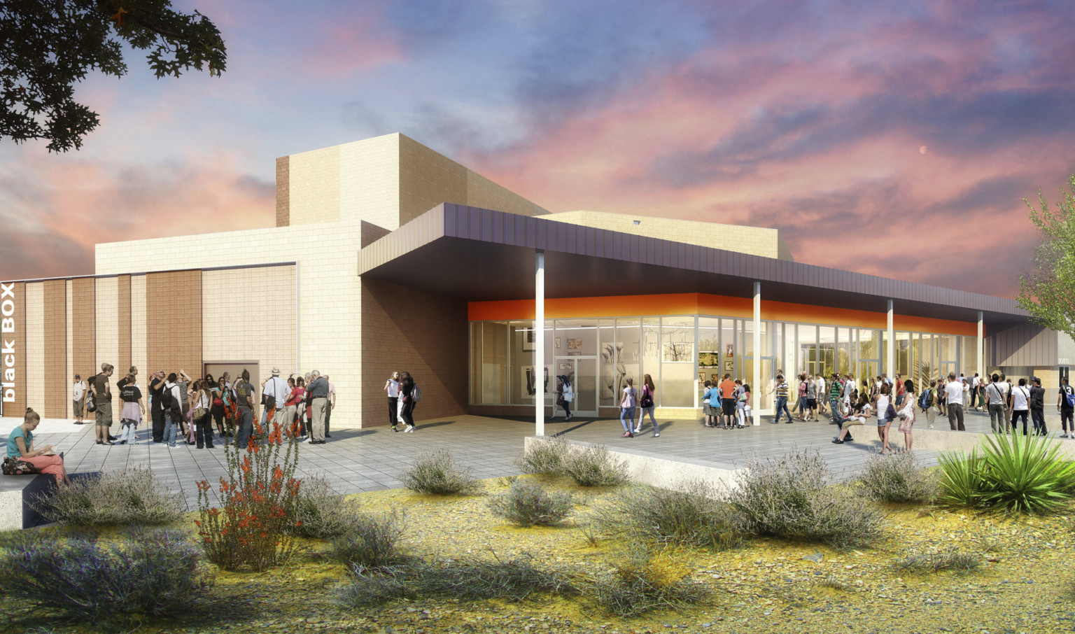 Exterior view of J.O. Combs High School Auditorium, orange accent over floor to ceiling window entry of beige building