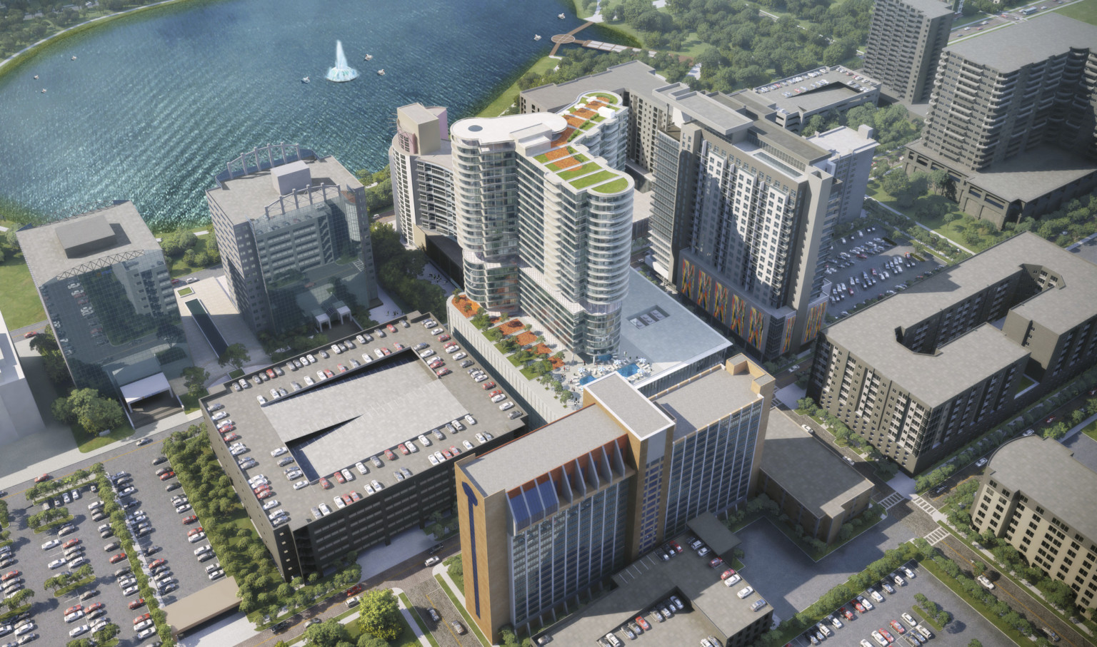 Aerial view of back of building with roof top gardens and pool in city near water