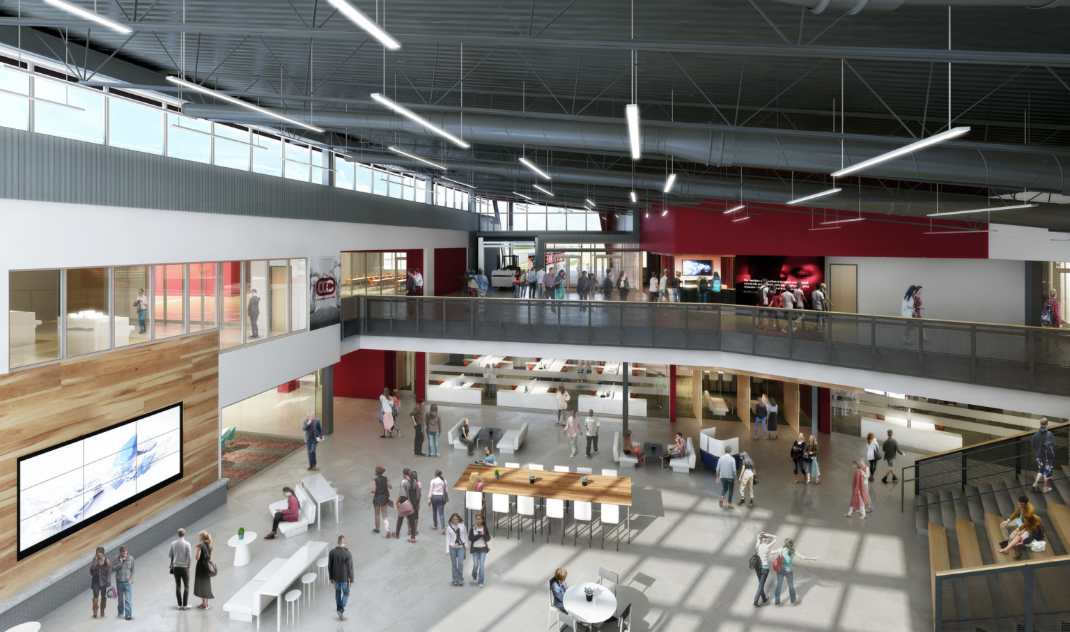 Double height atrium with learning stairs, right, to 2nd floor hallway and classrooms. Mixed seating below with wood accents