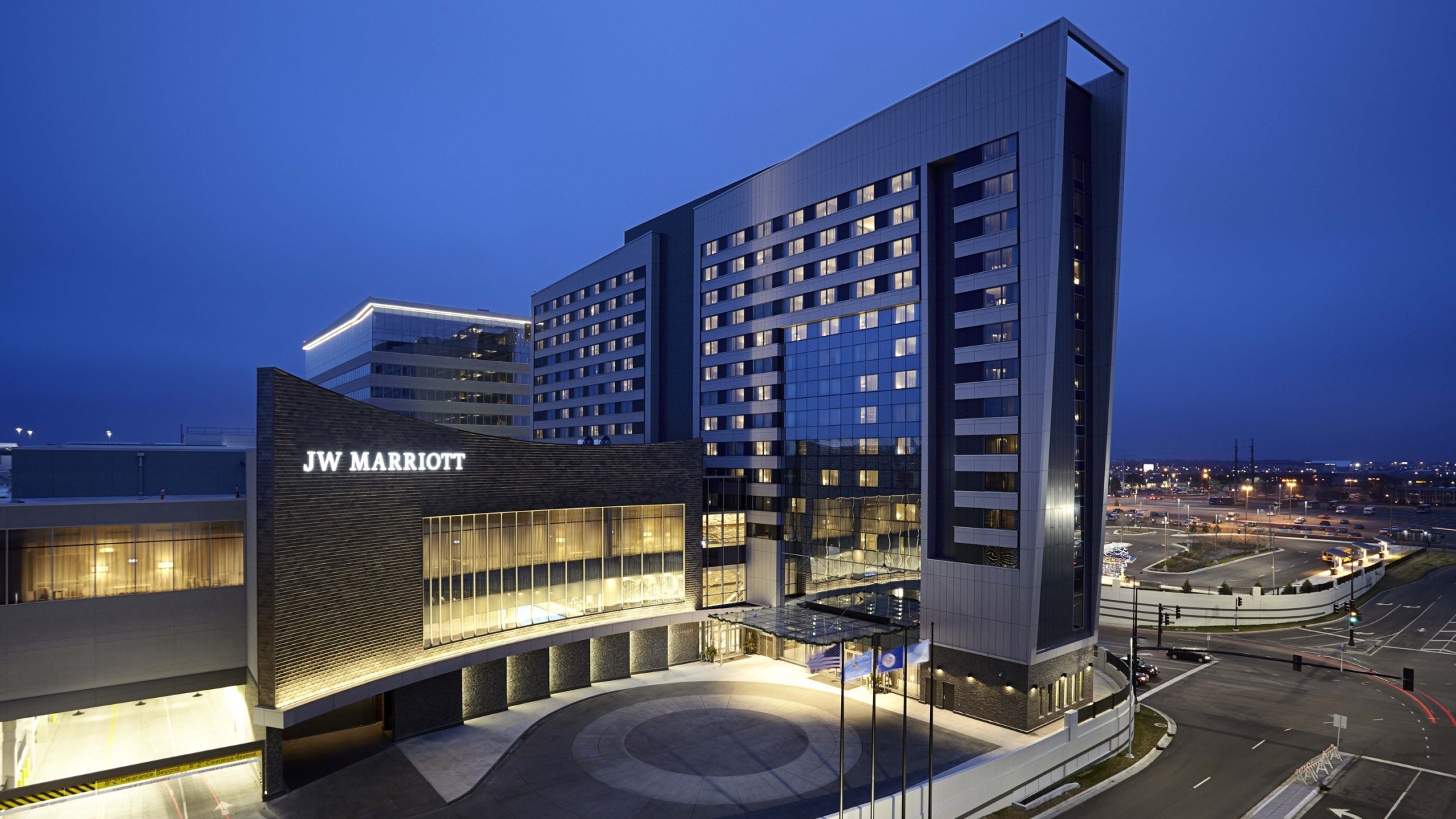 The JW Marriott Hotel and Mall of America illuminated at night. Sign lit on dark wall above double height windows