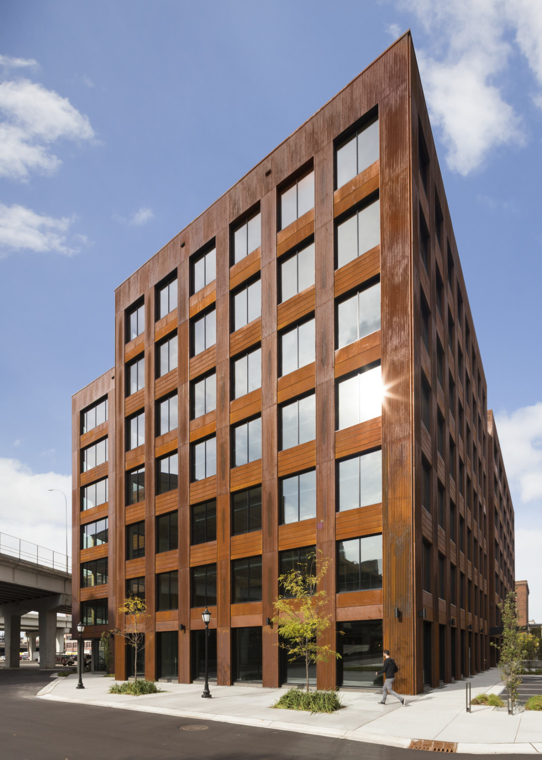 Corner view of mass timber building with large square windows