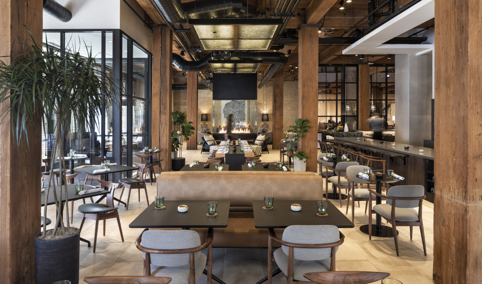 Dining area at Canopy by Hilton Minneapolis Mill District. Wood ceilings and columns with white accents and exposed steel