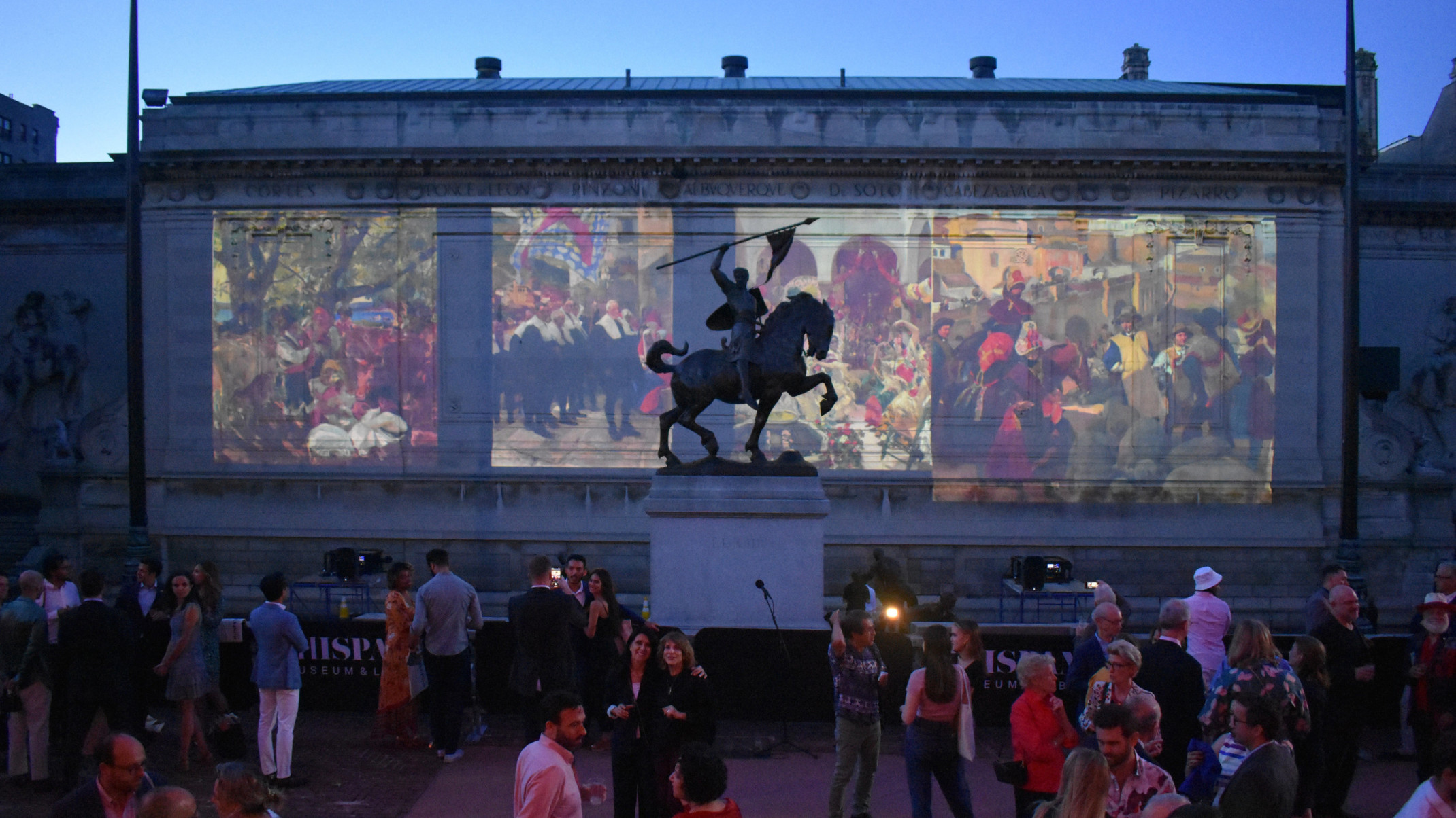 The Hispanic Society of New York, paintings projected on the side of the building beyond a sculpture of a man on horseback