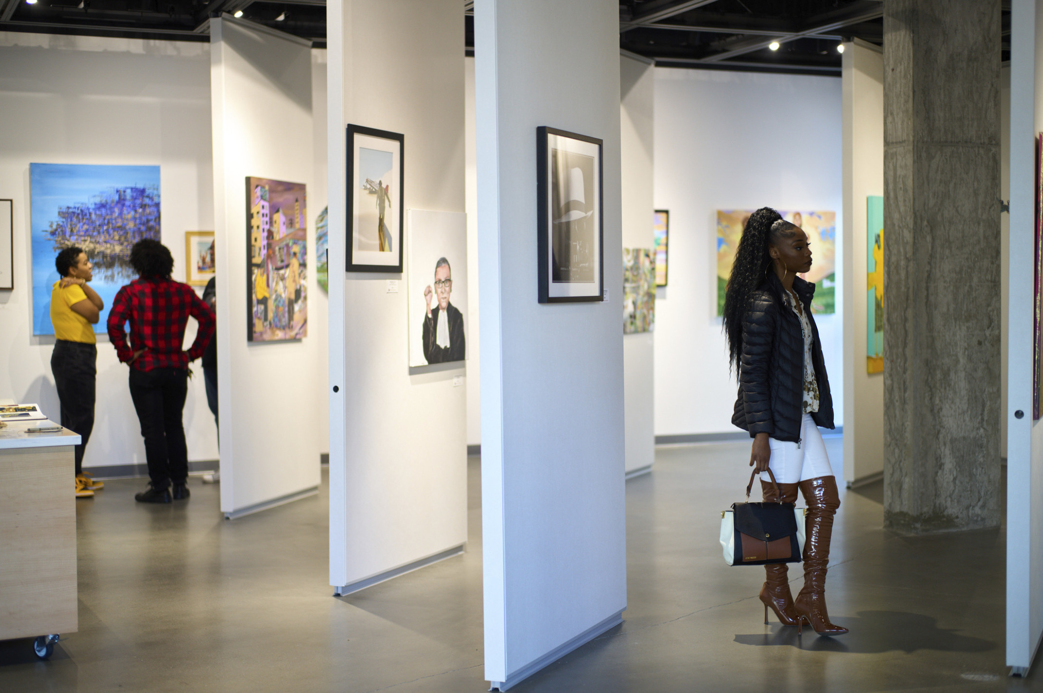 white walls with art, gallery, concrete pillar, gallery opening, people viewing and discussing art