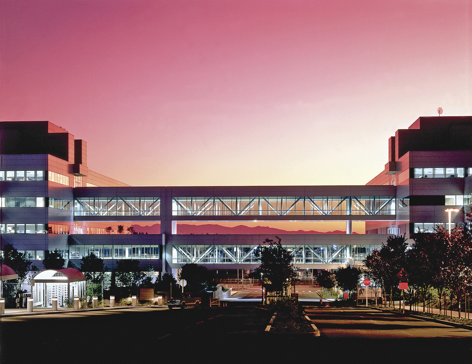 Boeing Everett 777 Office Complex at sunset with pink sky illuminating breezeway above two-way street