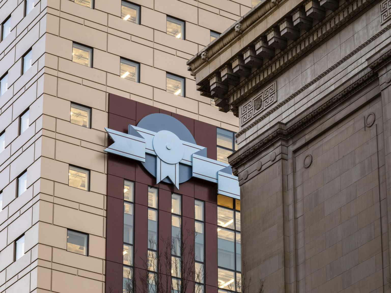 Stone facade and red stripe design with blue 2 tone ribbon shaped details at The Portland Building