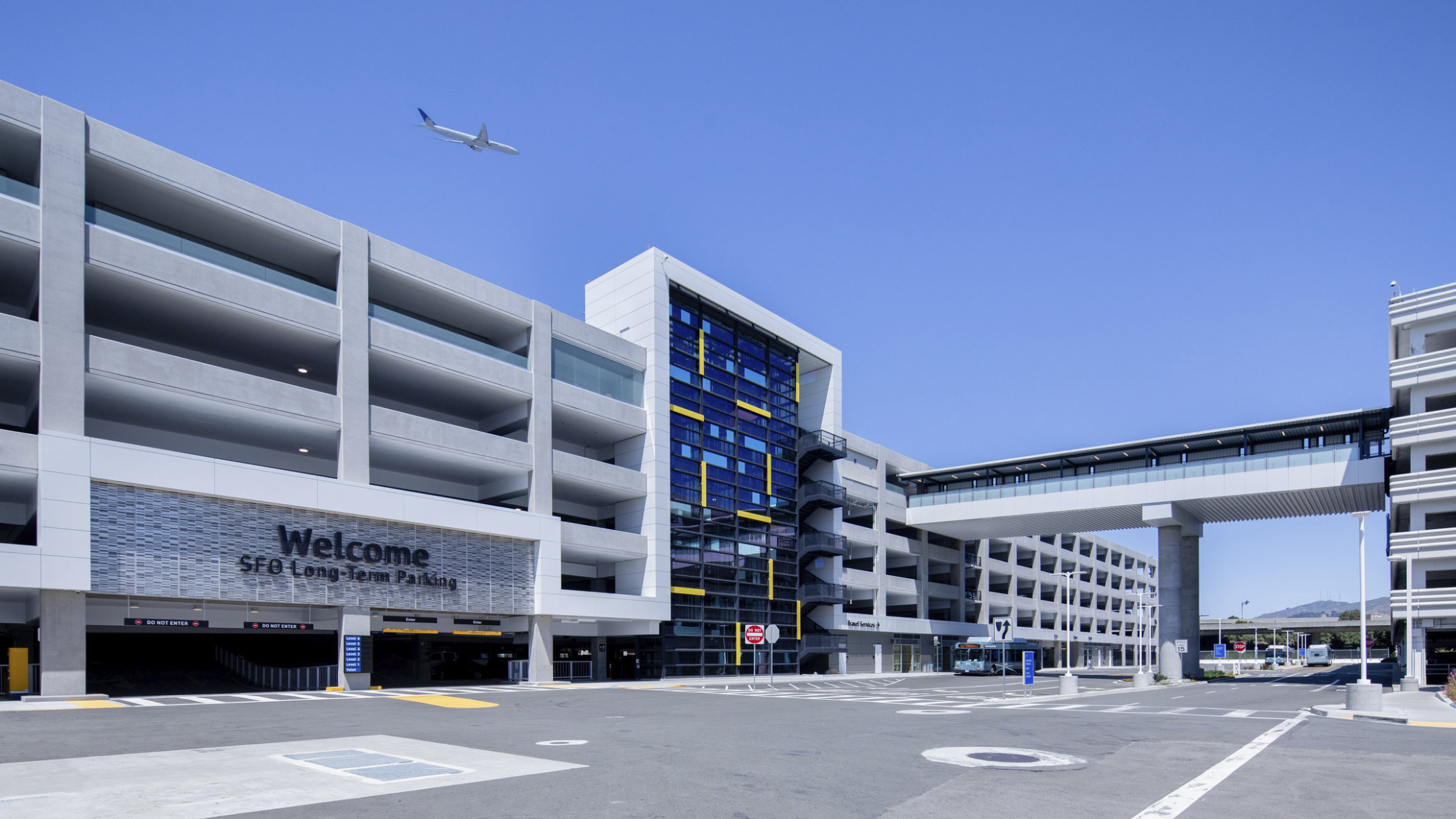 San Francisco International Airport Long Term Parking Garage, 6 stories with glass facade center and stairs. Entrance to left