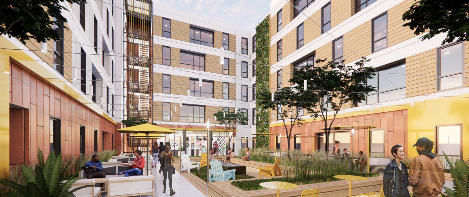 courtyard with wooden planters and seats, soft seating, and colorful metal seats and umbrellas. surrounded by buildings.