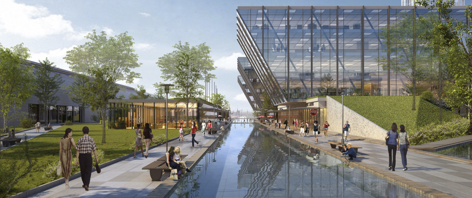 pedestrians walk along reflective pool between angular mixed-use buildings with full height windows