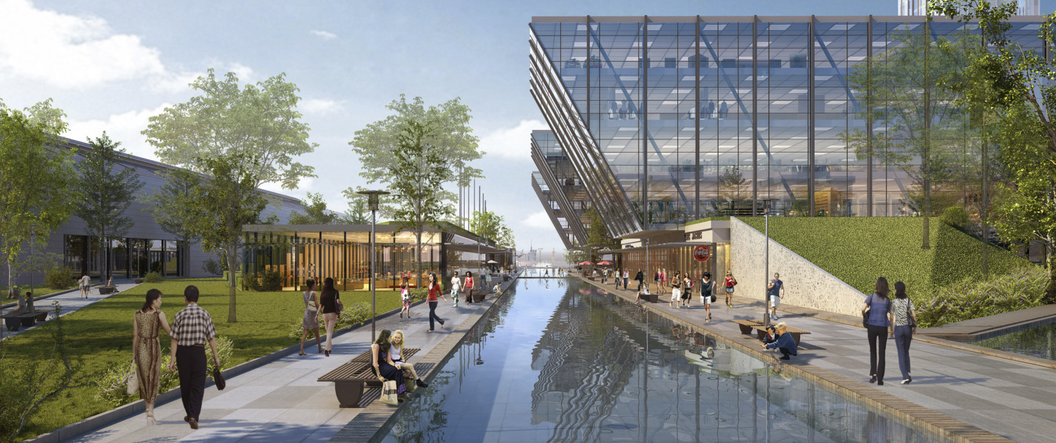 pedestrians walk along reflective pool between angular mixed-use buildings with full height windows