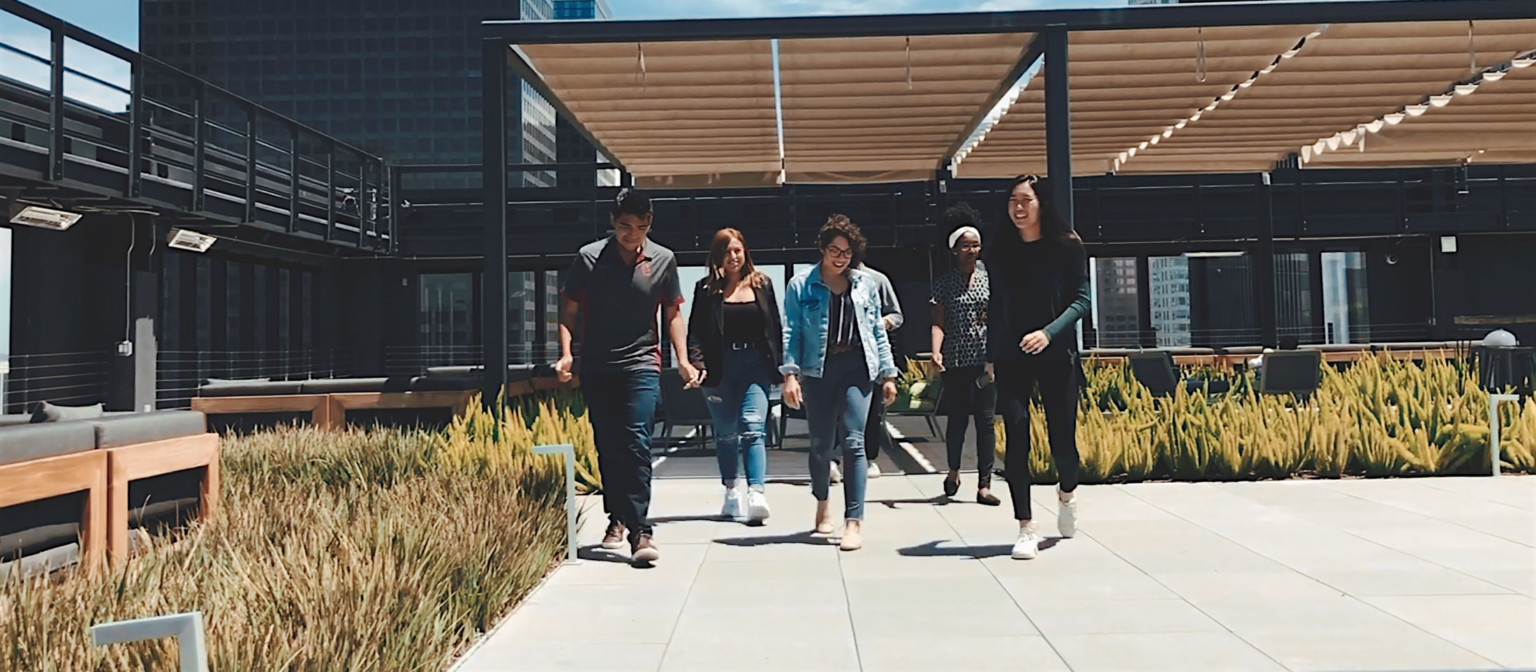 young professionals on an urban rooftop with wood slat canopy young professionals on an urban rooftop with wood slat canopy