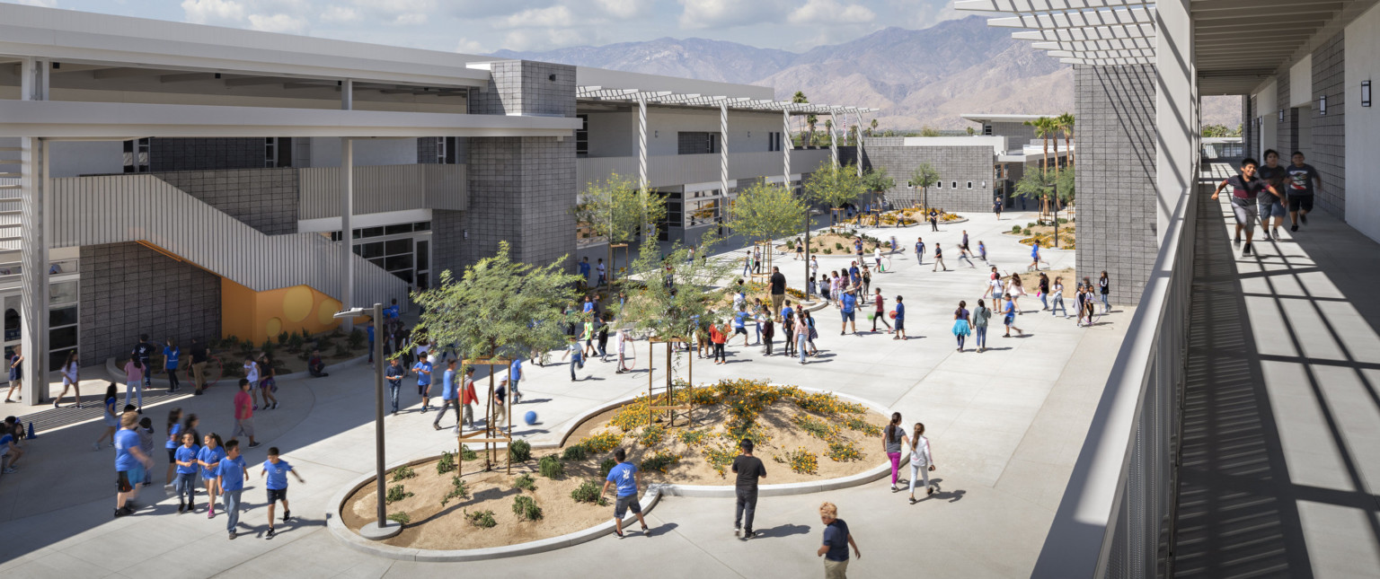 Agua Caliente Elementary School courtyard viewed from 2nd floor exposed walkway. Round garden spaces between 2 story building