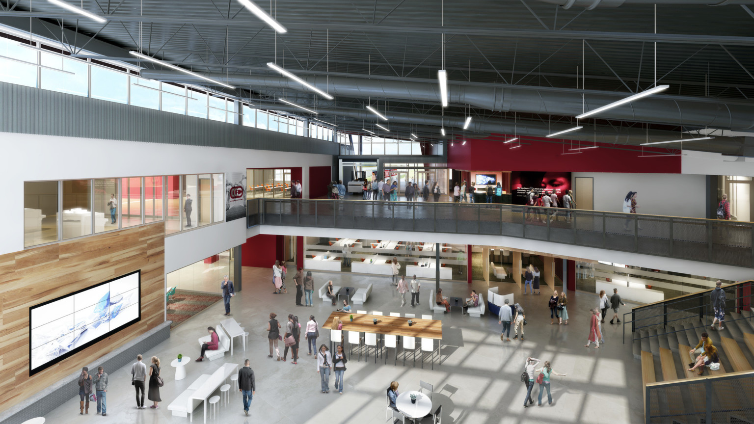 Double height atrium with learning stairs, right, to 2nd floor hallway and classrooms. Mixed seating below with wood accents