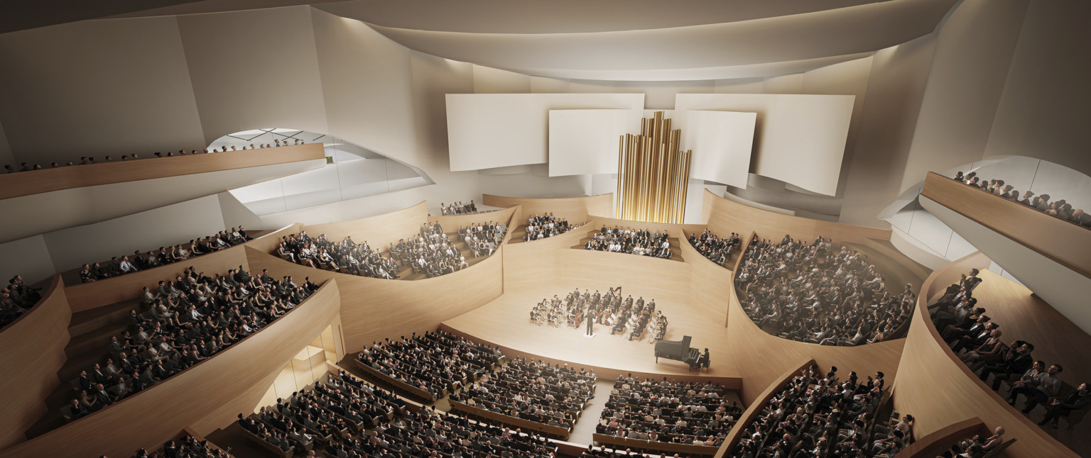 Theater interior with light wooden balconies surround the stage, behind center seating gold pipes with white acoustic panels