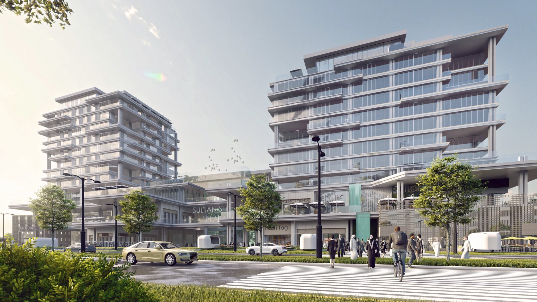 Entrance of Sultan Street Plaza with outdoor dining in front of 3 floor shopping center and floor to ceiling window apartment Entrance of Sultan Street Plaza with outdoor dining in front of 3 floor shopping center and floor to ceiling window apartment