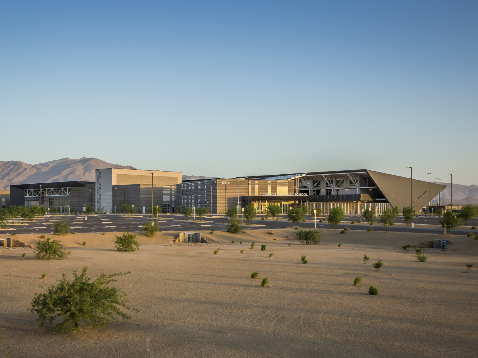 Exterior view of Canyon View High School, an angular multistory building with black wrapped roof to back