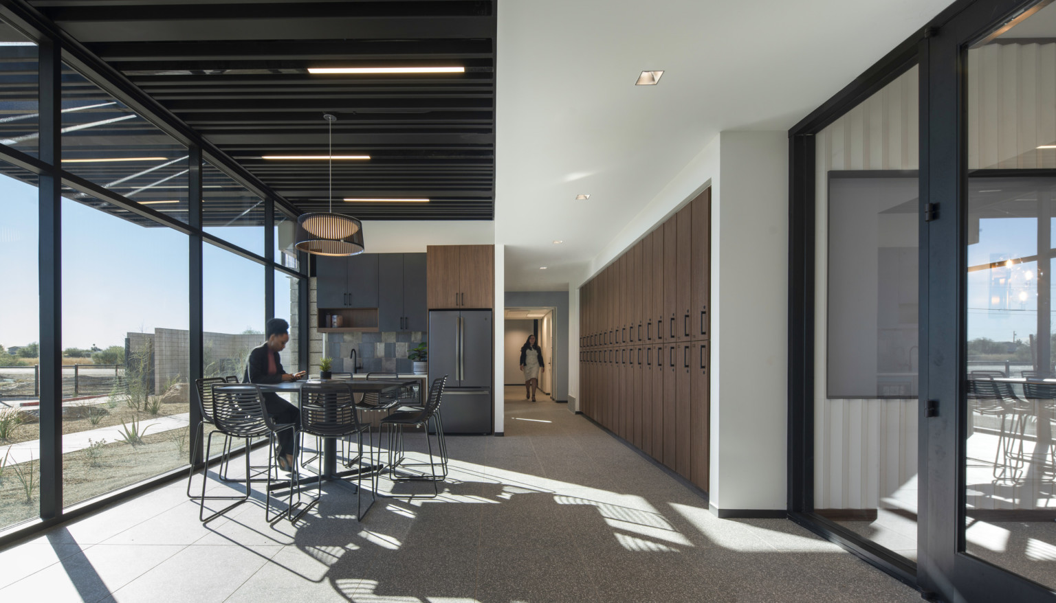 Interior office space with industrial style beams and wooden storage cabinets