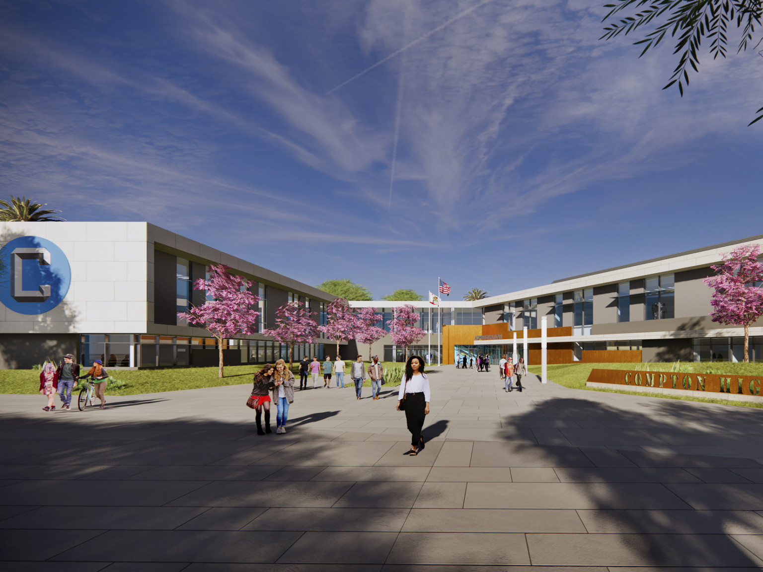 Compton High School entrance. A 2 story angled U shaped building with white wrapping facade. Blue logo on end of extension