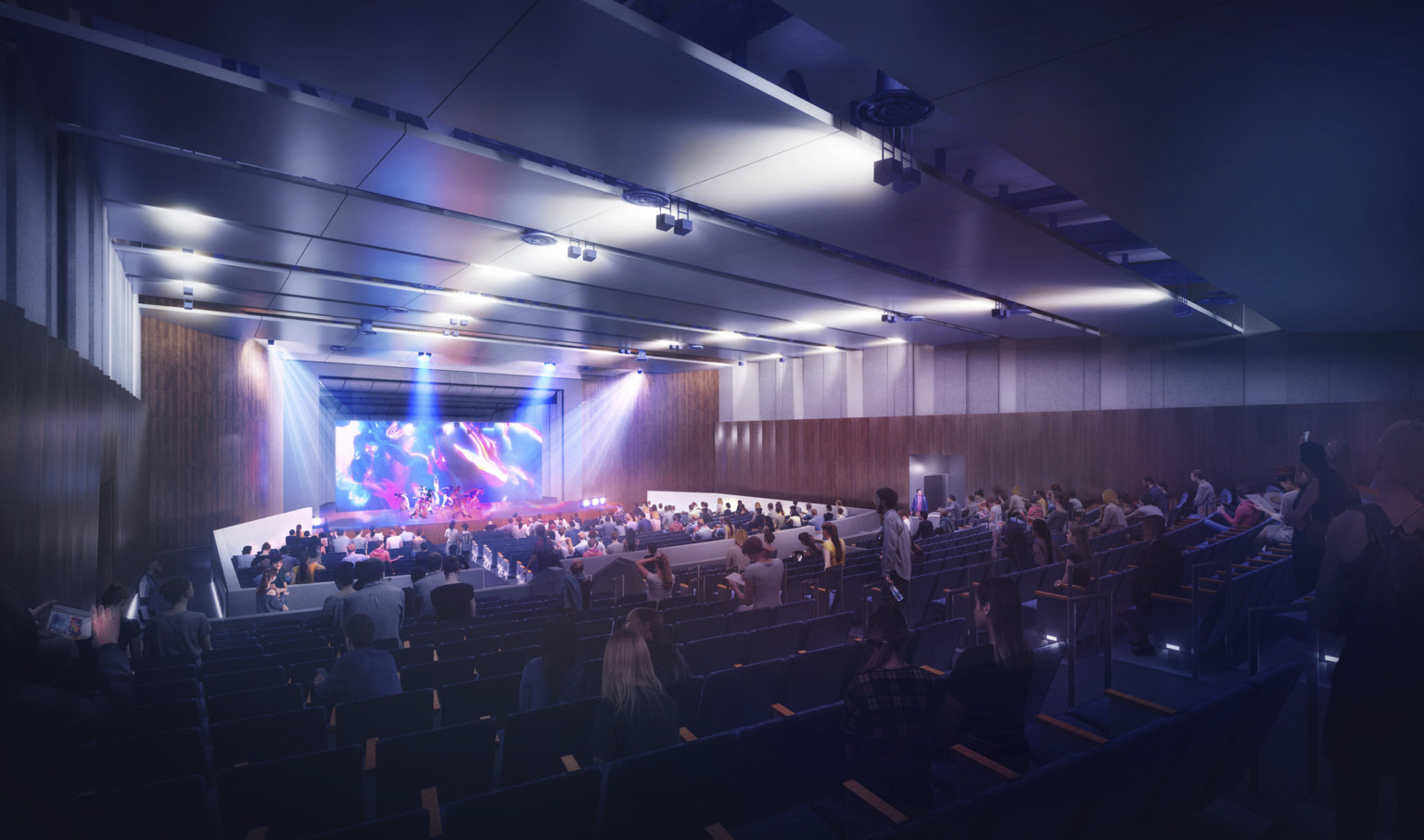 Stage in Compton HS auditorium with lines of acoustic panels across ceiling, multicolor spotlights, illuminated backdrop