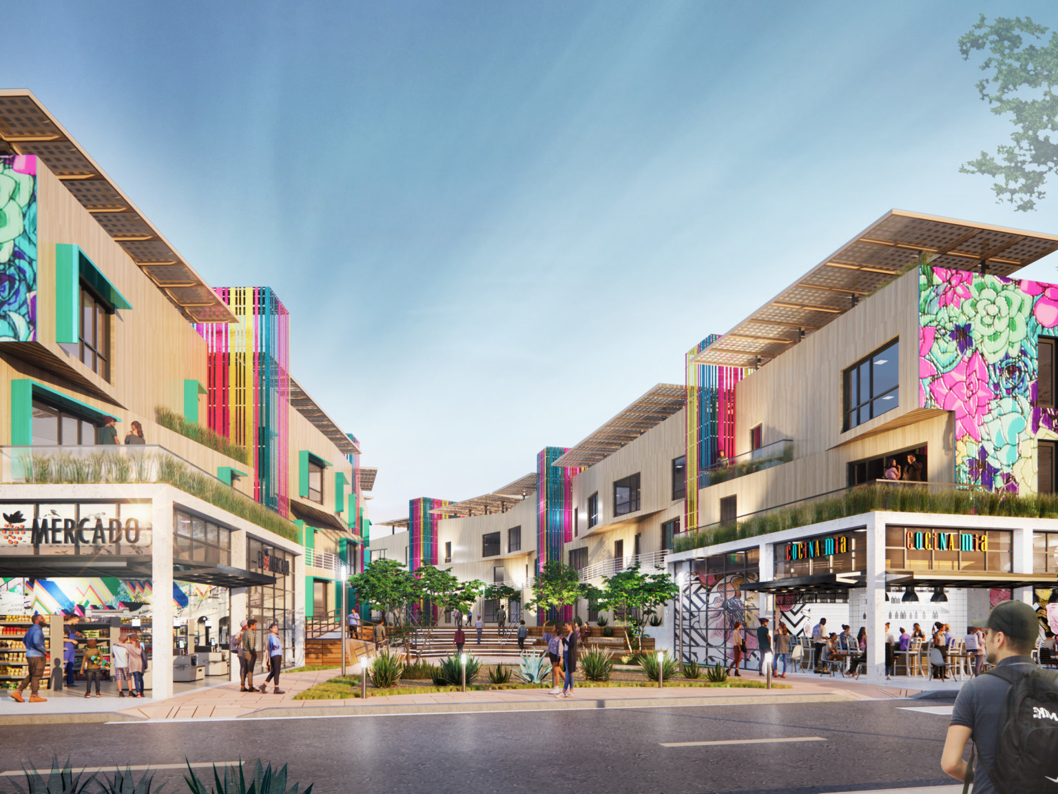 Semillas y Raices mixed use housing development entrance with shops on 1st level, apartments above on either side of walkway