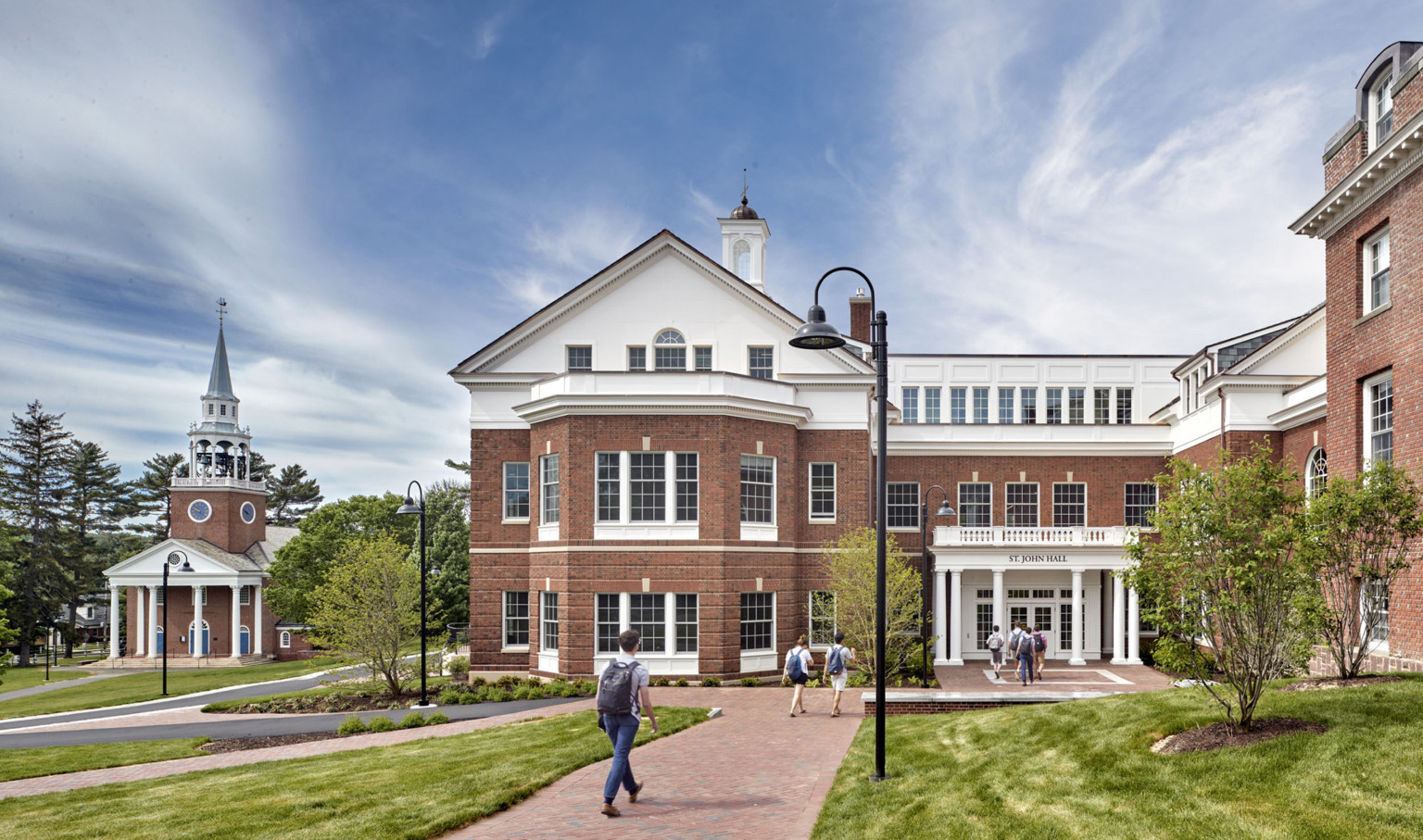 Choate Rosemary Hall, a neo-colonial red brick three-story building with entryway facing green lawn. Sign reads St. John Hall