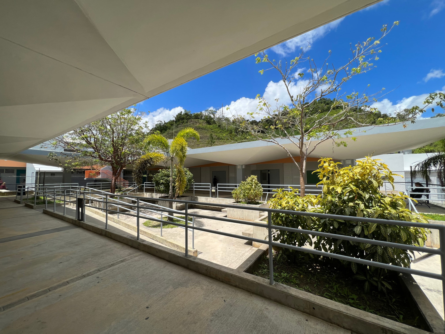 Puerto Rican Elementary School Urbana Violeta Reyes interior courtyard with covered walkways in front of large hills