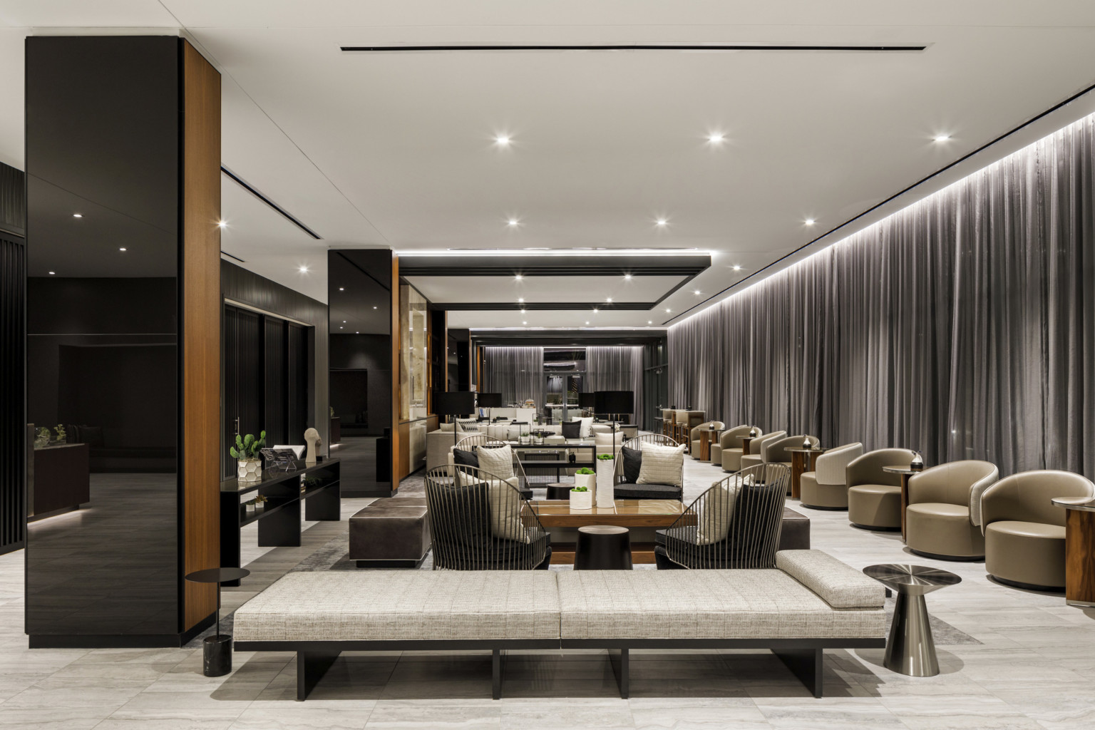 lobby with black mirrored columns white ceiling and gray drapes seating clusters with upholstered chairs and metallic tables lobby with black mirrored columns white ceiling and gray drapes seating clusters with upholstered chairs and metallic tables