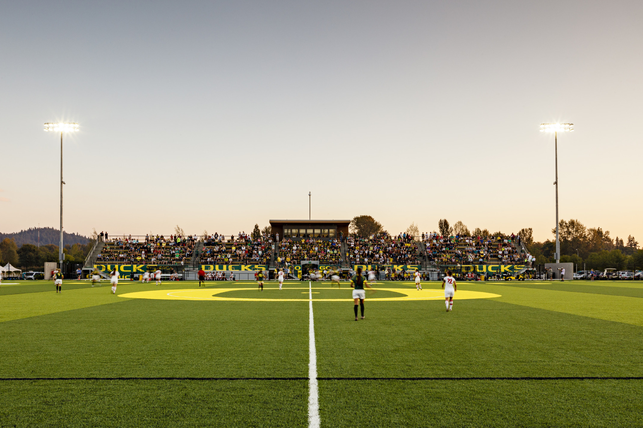 Papé Field, for University of Oregon womens soccer and lacrosse, seen from center line during game, bleachers reading Go Ducks