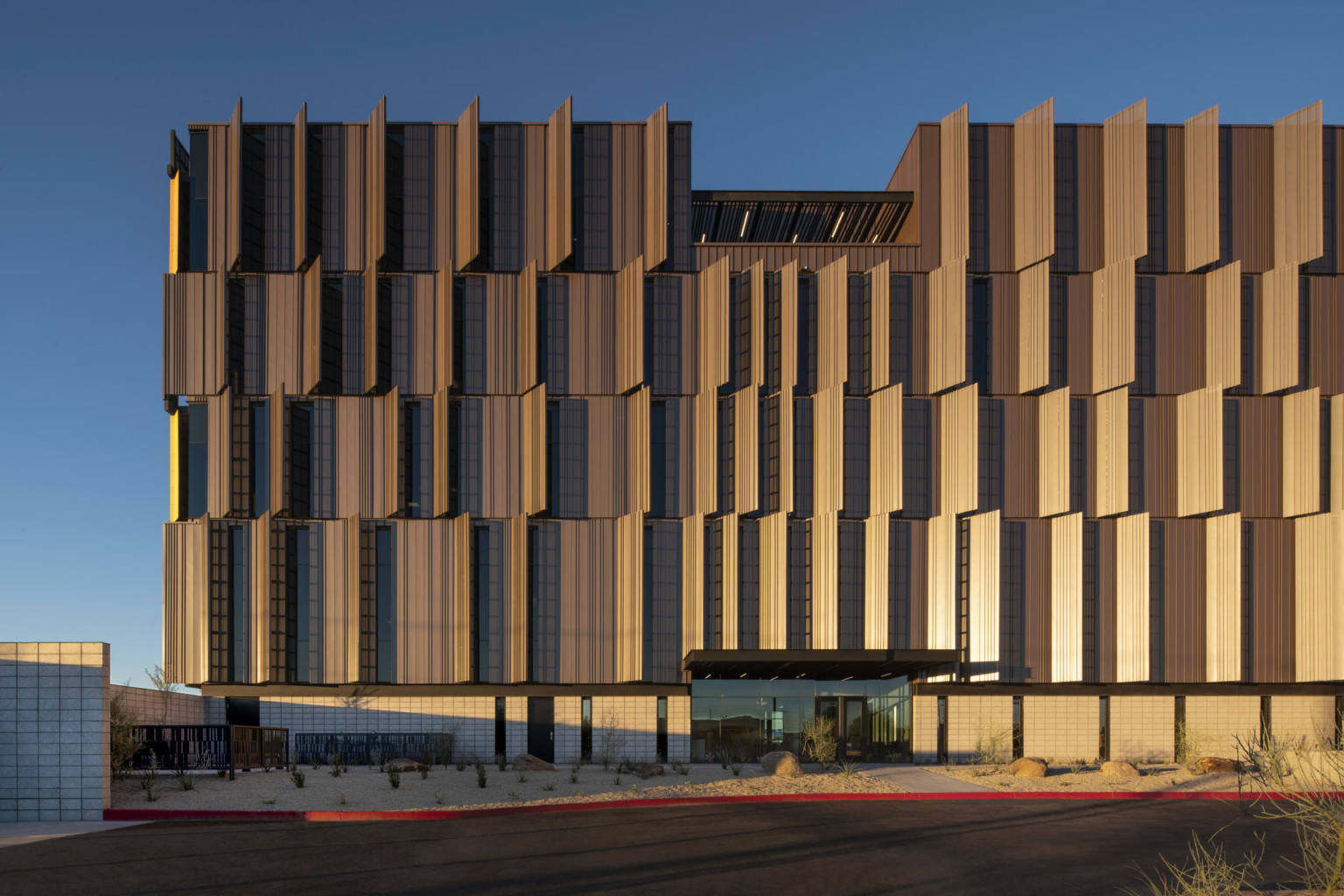 Dusk shot of Pinal County Attorney’s Offices, a serrated wrapped facade in alternating horizontal layers