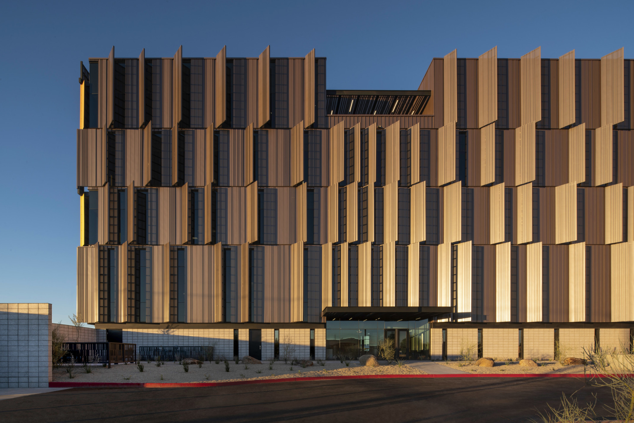 Dusk shot of Pinal County Attorney’s Offices, a serrated wrapped facade in alternating horizontal layers