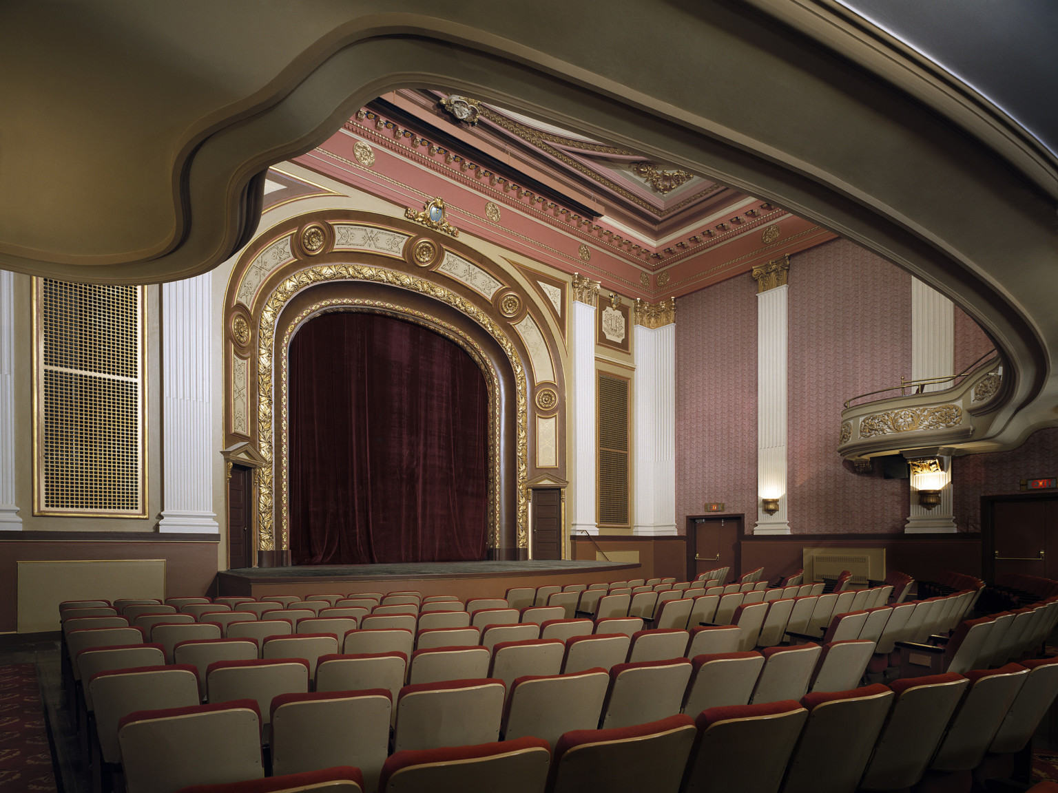 Appell Center interior looking to stage, view of base of curving balcony, elaborate gold and white moulding on proscenium