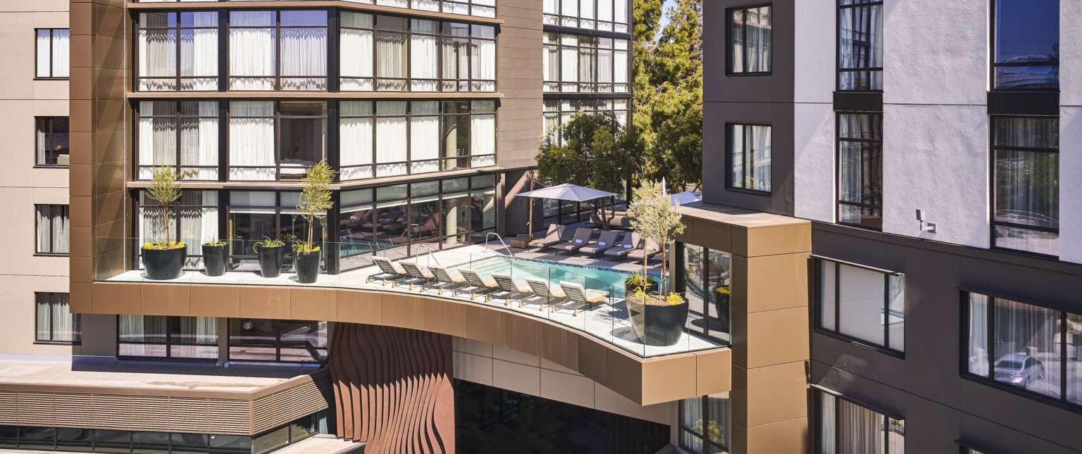 Ariel view of central breezeway featuring a heated outdoor pool on the third floor.