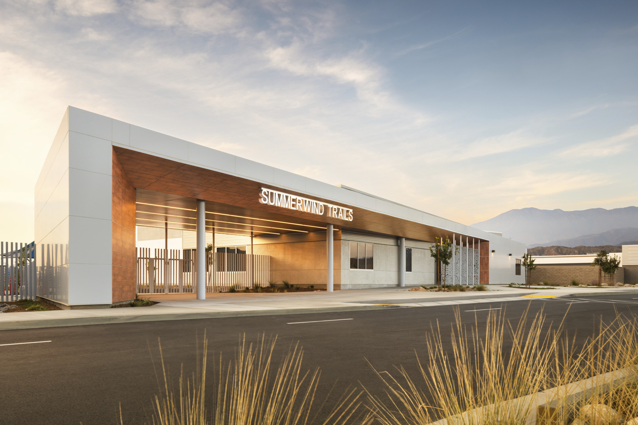 Exterior of Beaumont USD Summerwind K-8 School white wrapped facade canopies with brown base