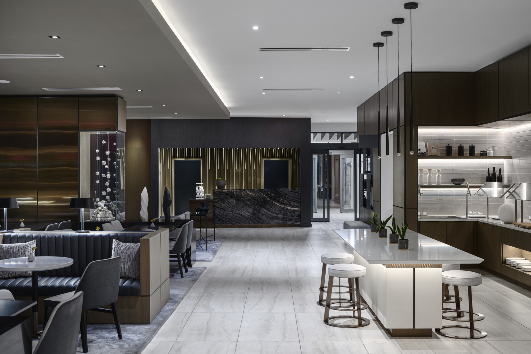 Overall view of lobby and lounge featuring layered artwork, millwork detailing, and dark stone with white stone and furniture