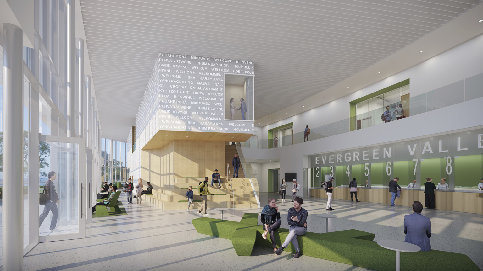 Open lobby space with wayfinding signage and numbered help desks to right in green alcove. Mixed seating, floor to ceiling windows