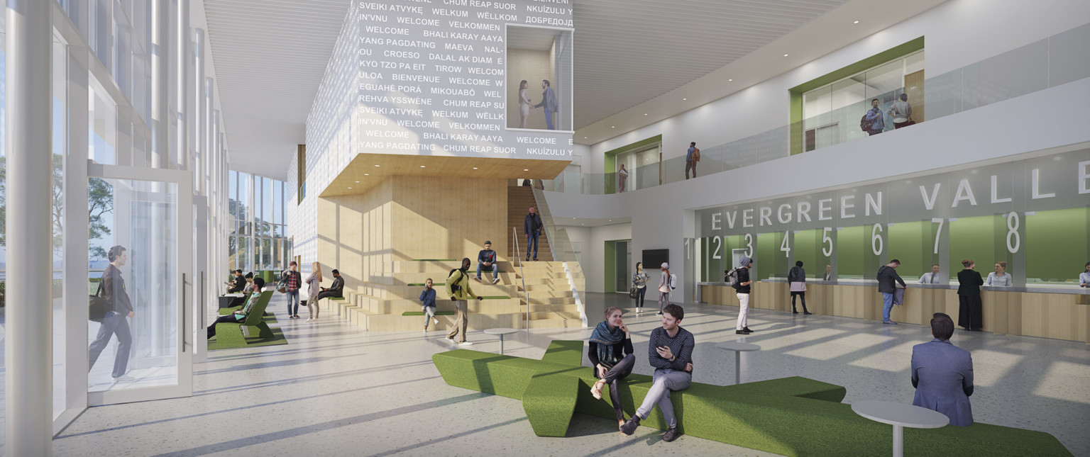 Open lobby space with wayfinding signage and numbered help desks to right in green alcove. Mixed seating, floor to ceiling windows