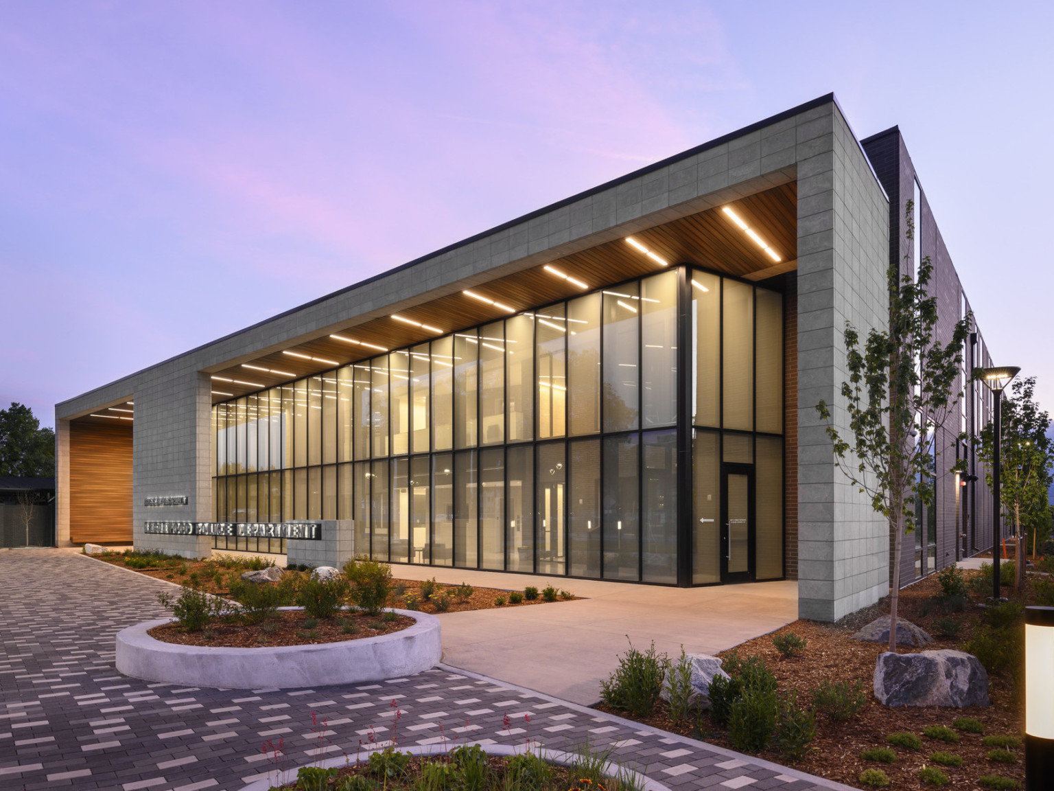 corner view of the Englewood Police Headquarters at dusk with entrance lit from above