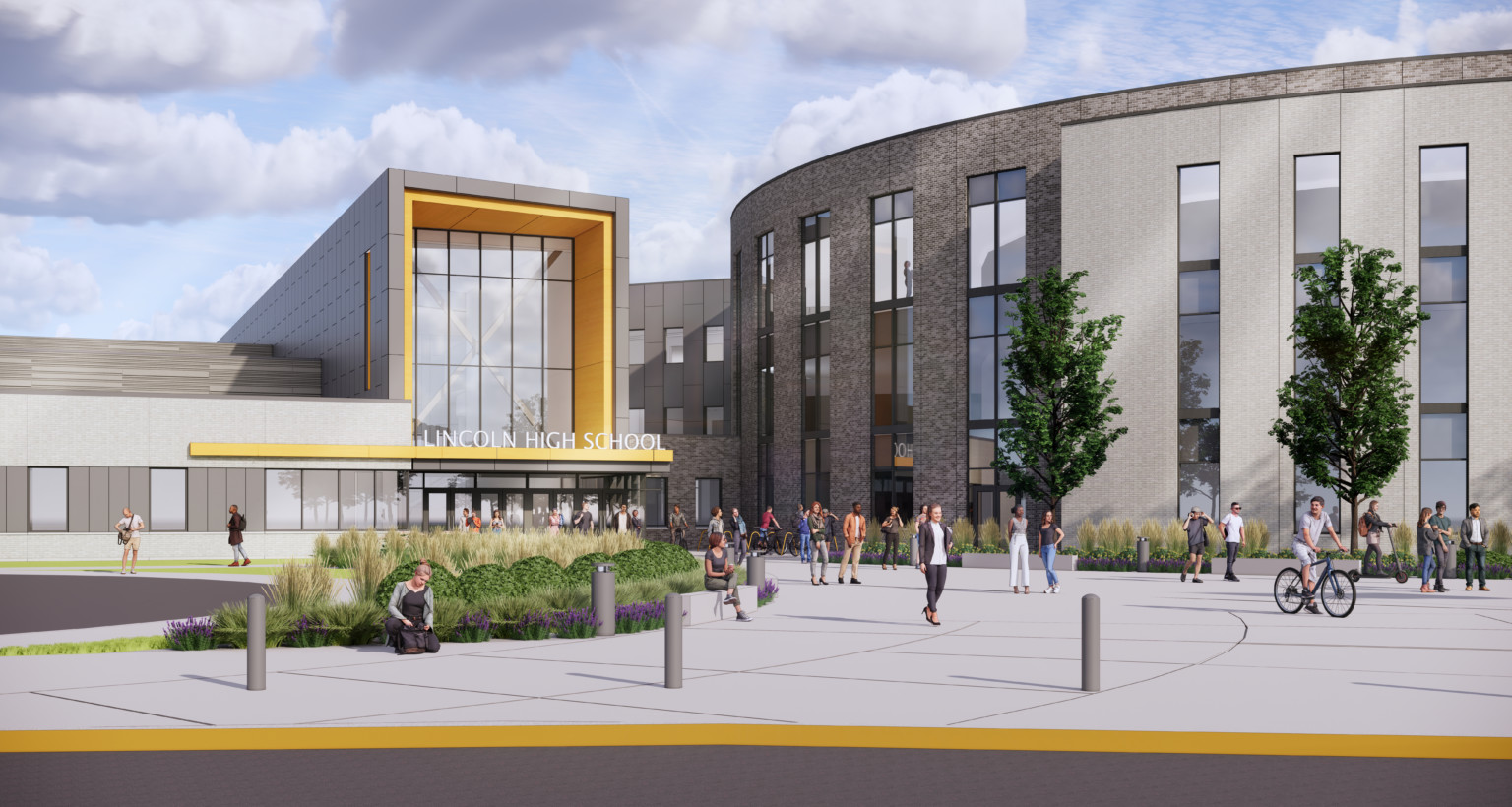 Front entrance to Lincoln High School. Landscaped sidewalk to 3 story building with covered entrance, round building to right