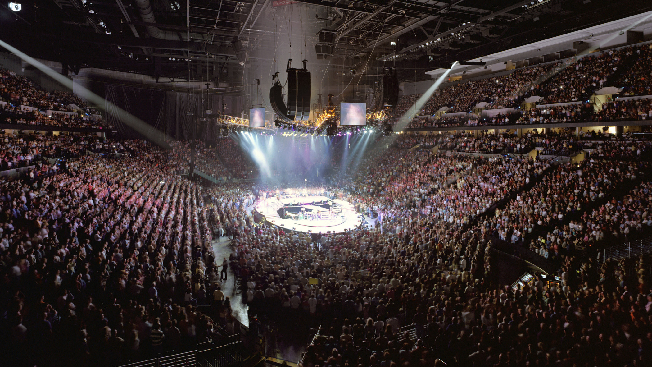 Chi Health Center Omaha interior event and sporting venue. Stadium seating filled during a concert performance with lighting above