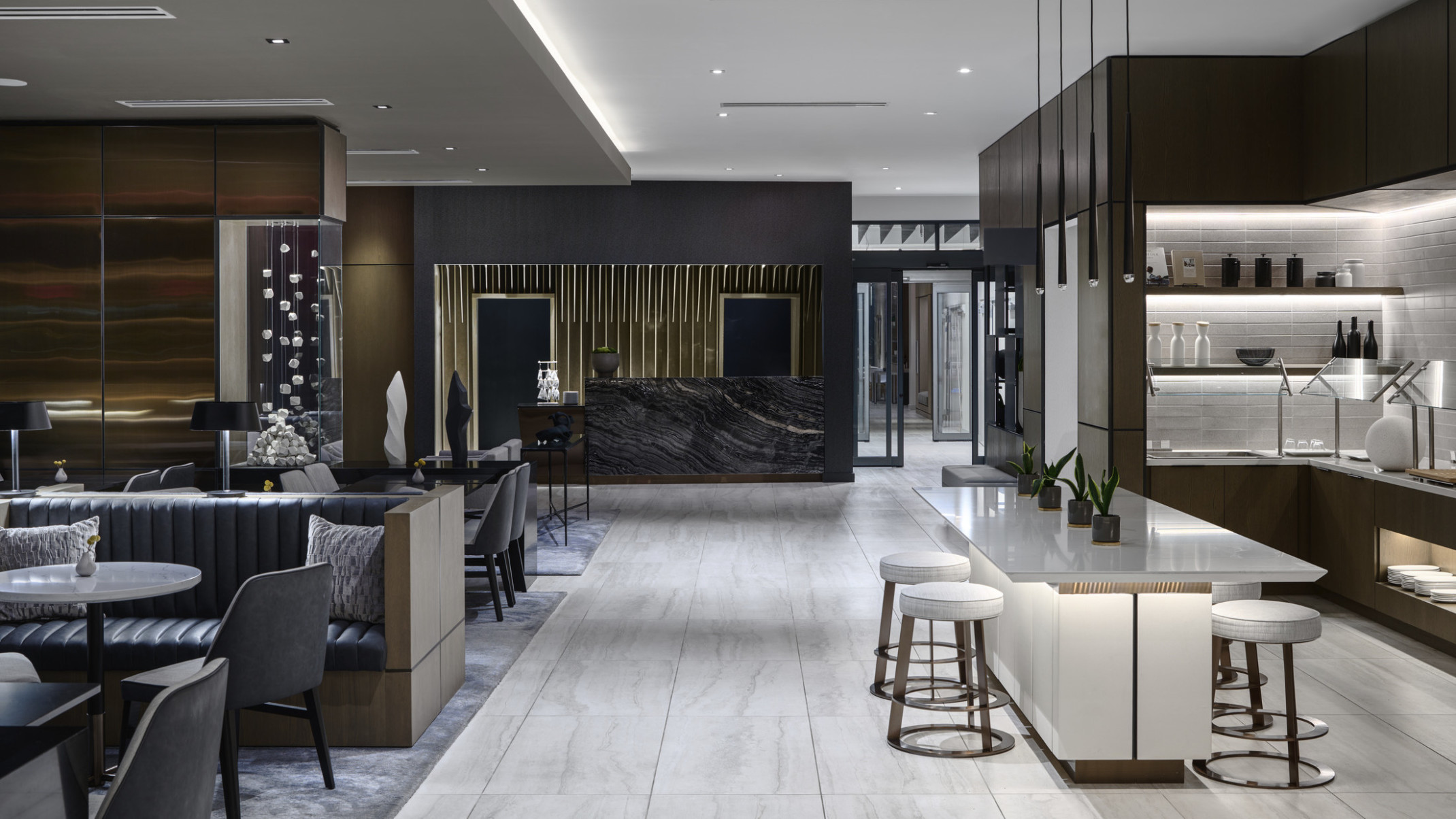 Overall view of lobby and lounge at a AC Hotel brand hotel featuring layered artwork, millwork detailing, and dark stone with white stone and furniture