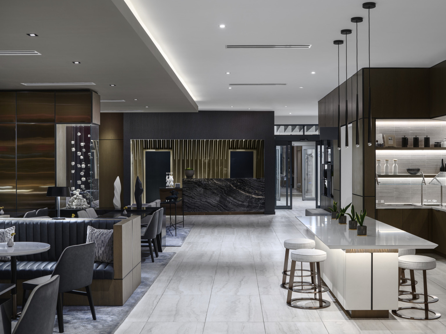 Overall view of lobby and lounge at a AC Hotel brand hotel featuring layered artwork, millwork detailing, and dark stone with white stone and furniture