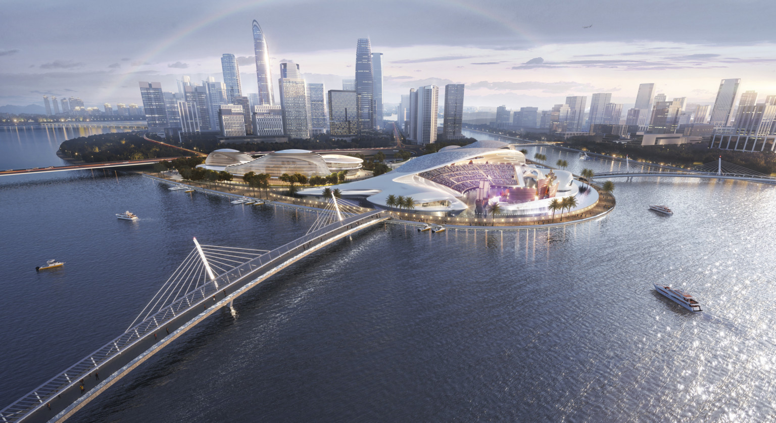 Xiamen Cultural Complex in China. Bridges connect to land with white sweeping multipurpose event center and stadium seating