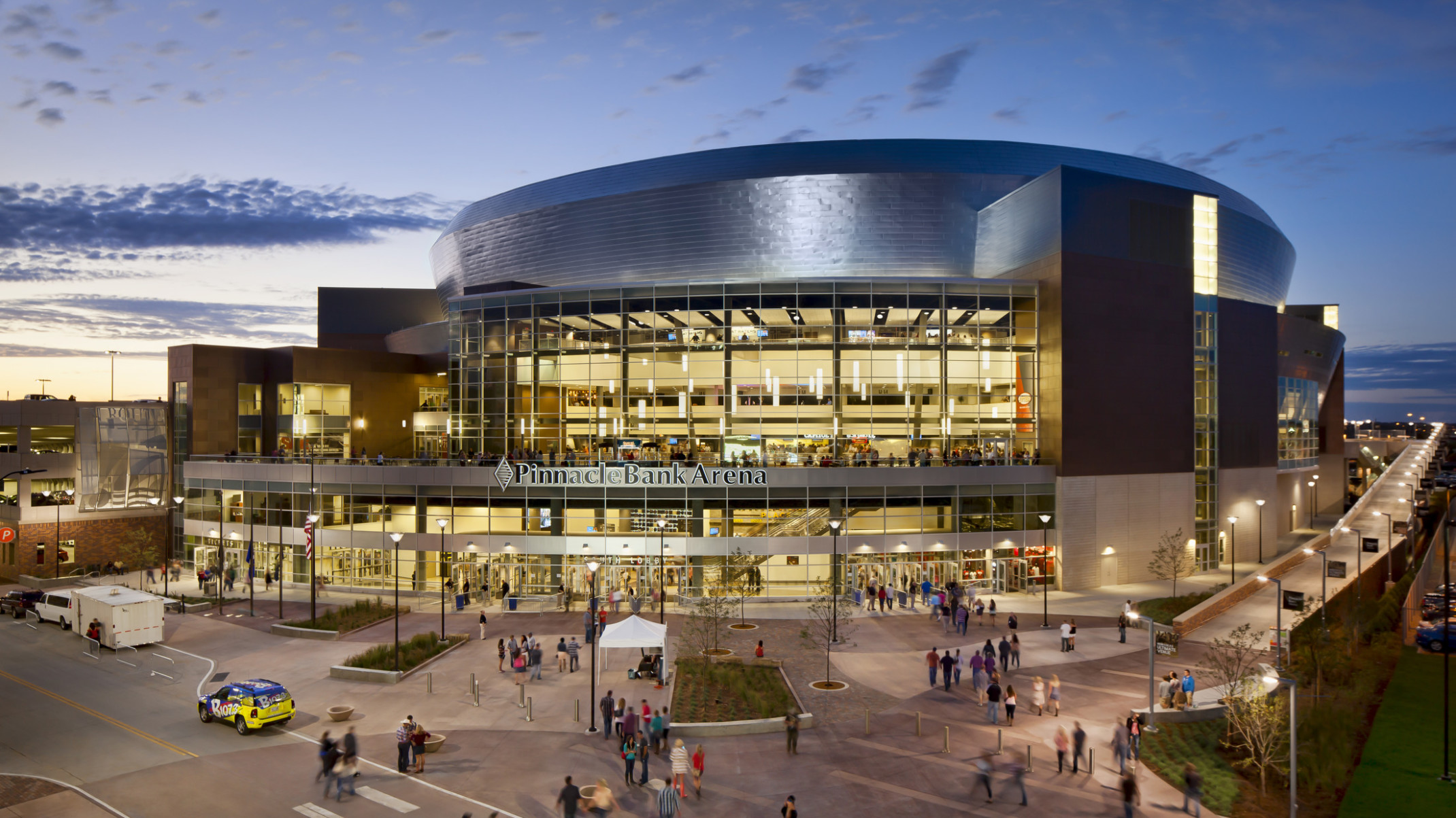 Exterior of Pinnacle Bank Arena in Lincoln Nebraska, a rounded multi story building with large windows and silver roof