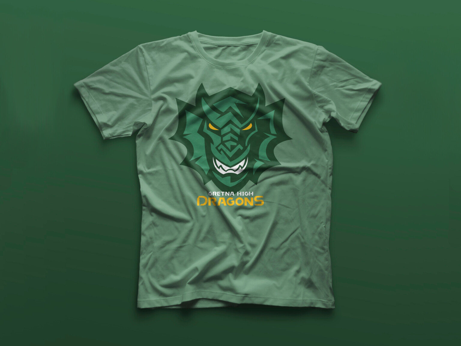 Green tshirt with green dragon logo. In yellow, below, reads Gretna High Dragons