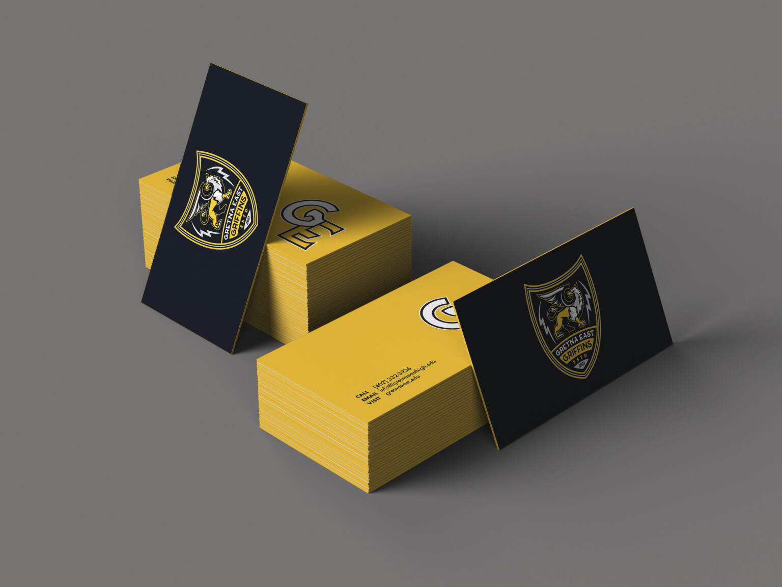 Black and yellow business cards with Gretna East High School logo on black side