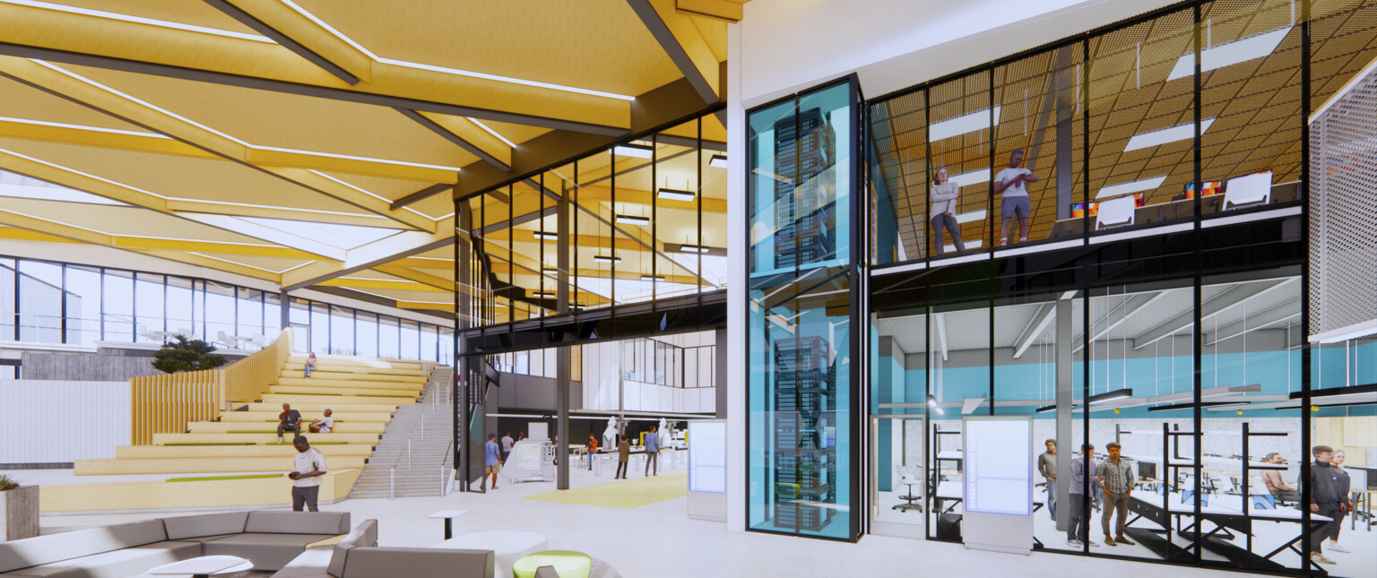 gray seating in front of bleacher style grand stair beside two floors of glass enclosed learning spaces with turquoise walls